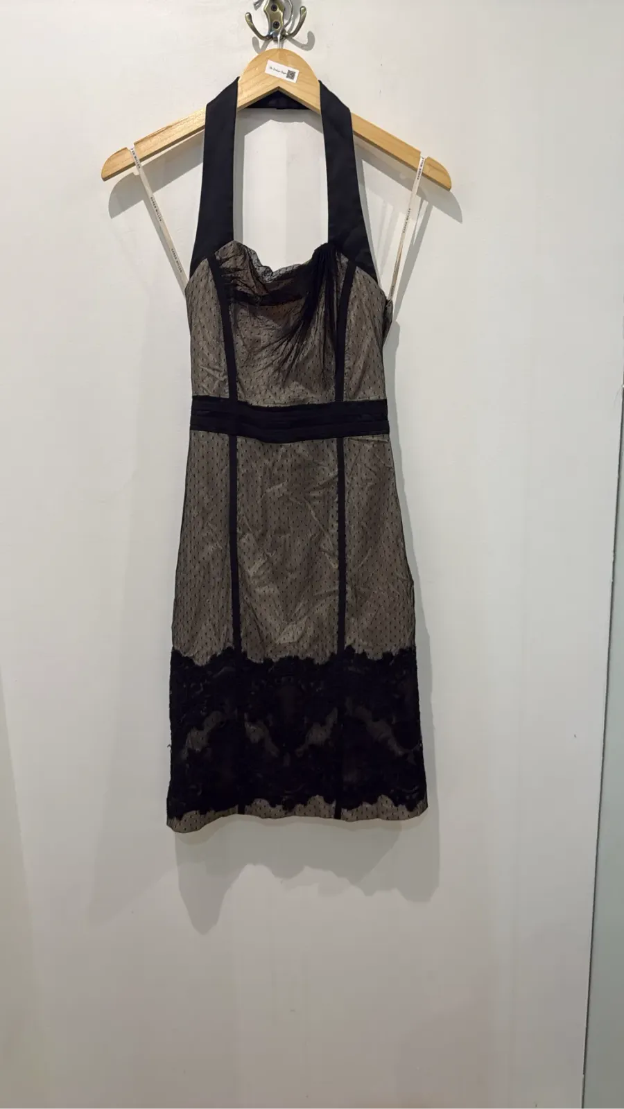 Short black Karen Millen halter-neck dress with a dotted-mesh panel and floral lace trim.