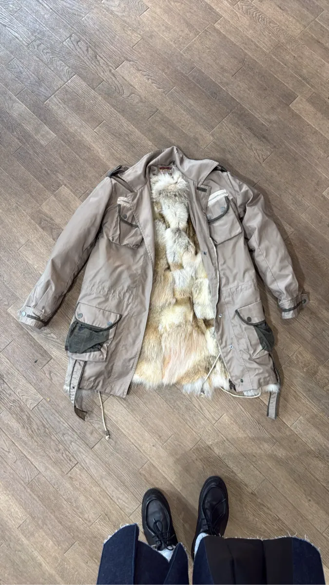 Parka Galliano beige avec doublure en fourrure naturelle renard amovible et détails de poches cargo imprimées.