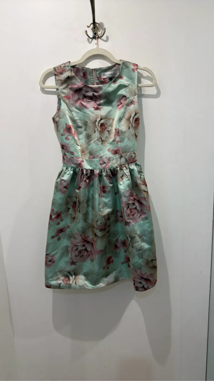 Mademoiselle Tara by Tara Jarmon sleeveless cocktail dress with light green and pink floral print, fitted cut and flared skirt.