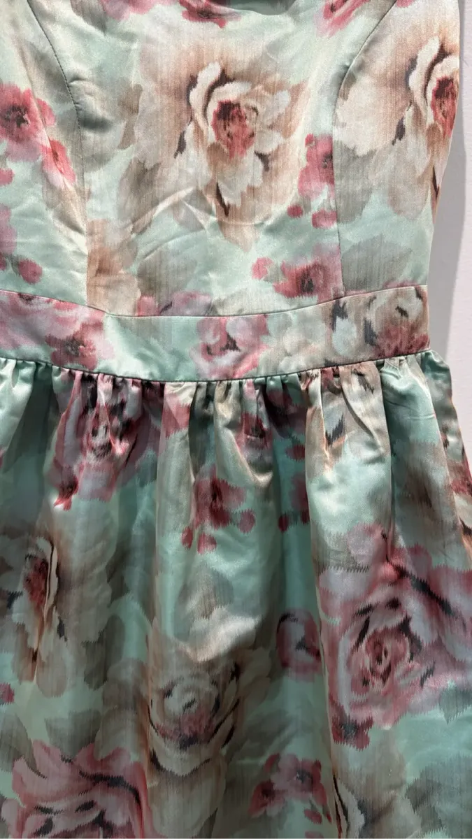 Robe de cocktail Mademoiselle Tara by Tara Jarmon sans manches à imprimé floral vert clair et rose, avec une coupe cintrée et une jupe évasée. 2