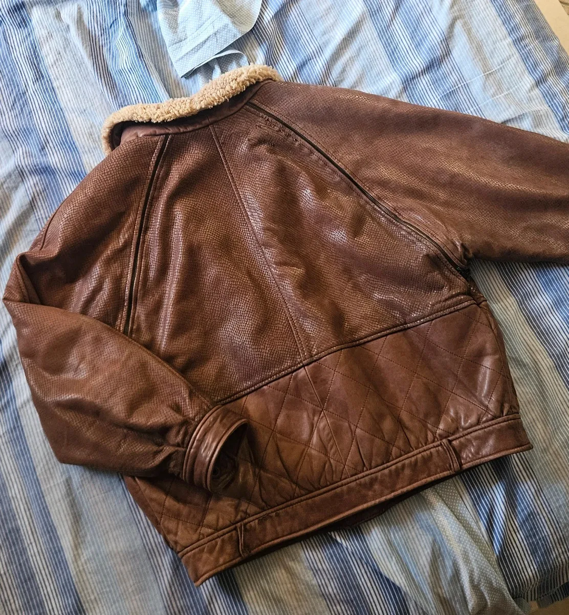 Cette veste VFORTI est confectionnée en cuir marron souple à motif serpenté. Les manches sont amovibles. Très bon état, avec quelques signes d'usure dus au temps. 3
