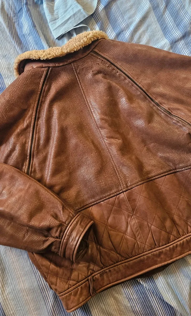 Cette veste VFORTI est confectionnée en cuir marron souple à motif serpenté. Les manches sont amovibles. Très bon état, avec quelques signes d'usure dus au temps. 6