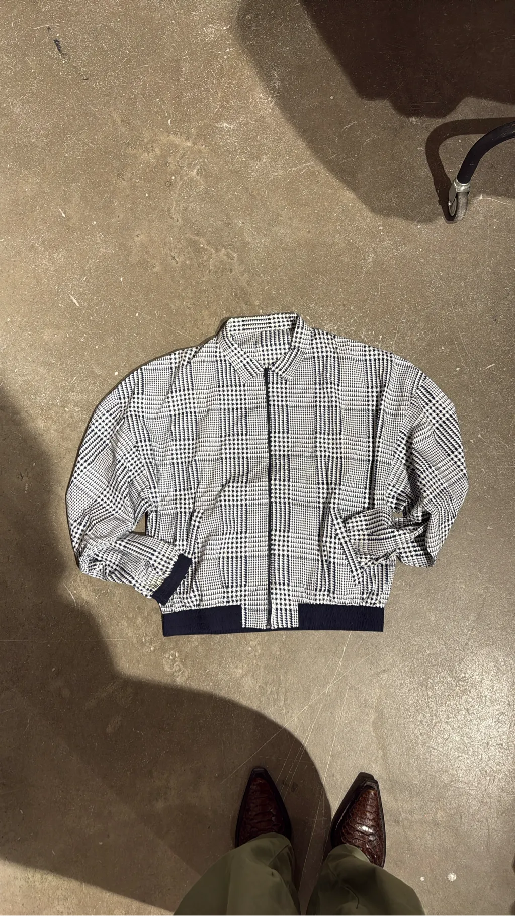 White and navy houndstooth bomber jacket with ribbed trim, size XL.