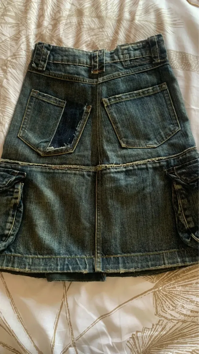 Taille XXS soit 32 cm à plat
Modèle rare
Jupe en denim authentique de la marque Marithé + François Girbaud, au design original et travaillé.
Coupe courte avec détails cargo et effet patchwork, typique de la marque.
✔️ Nombreuses poches (avant + côtés)
✔️ Détails effilochés et coutures apparentes pour un look vintage
✔️ Denim épais et de qualité
✔️ Fermeture boutons / à noter qu’il manque un bouton en métal (voir dernière photo) mais ne se voit pas une fois porté
✔️ bon état général / prévoir un lien de serrage
Taille XS
Couleur : bleu denim légèrement délavé
Parfaite pour un look casual, streetwear ou Y2K. Se porte facilement avec un t-shirt, un débardeur ou une veste en jean. 4
