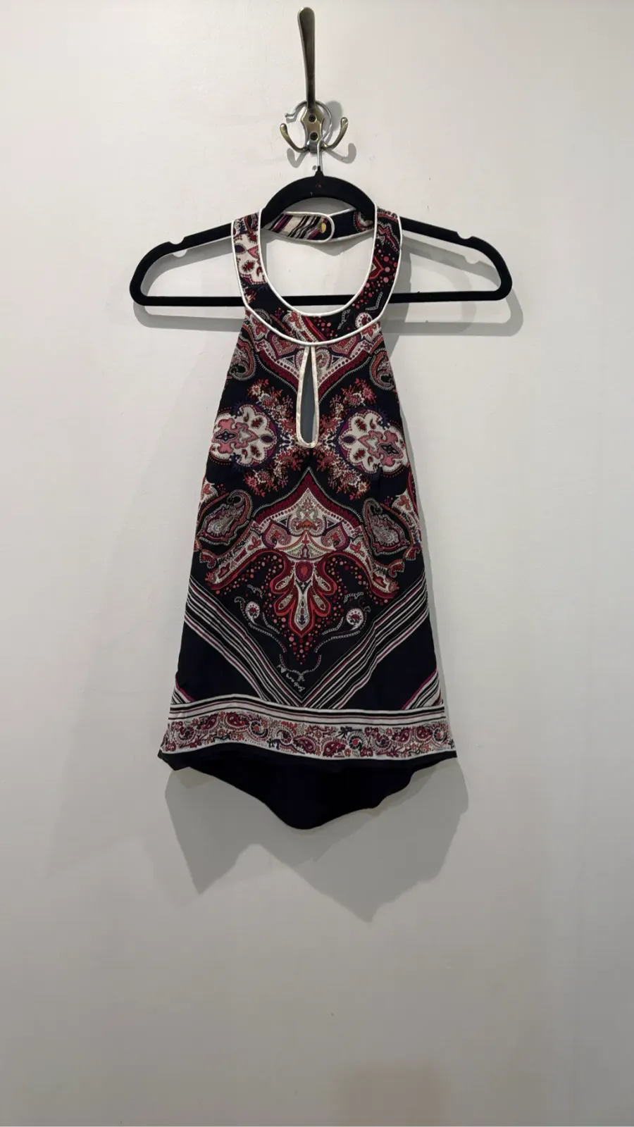 Black women's top with multicoloured paisley pattern, halter neck and teardrop detail.
