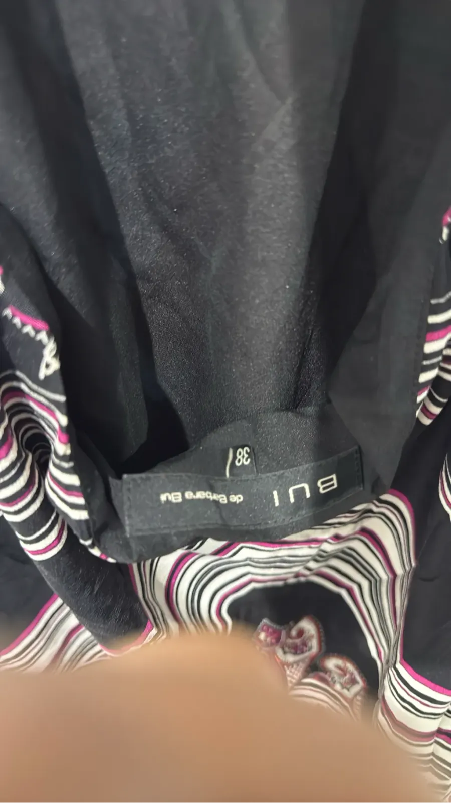 Black women's top with multicoloured paisley pattern, halter neck and teardrop detail. 4