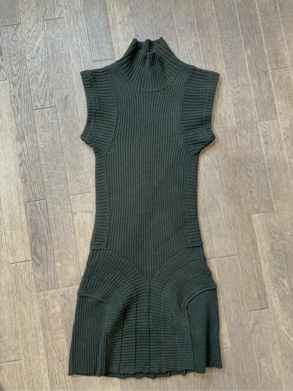 Robe courte en maille côtelée vert foncé avec col montant et manches courtes.