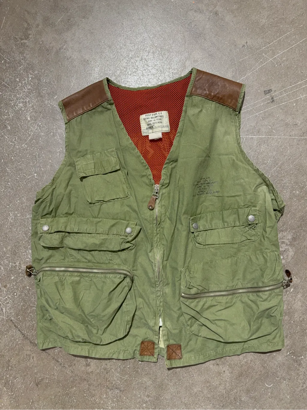 Gilet utilitaire vert kaki Avirex inspiré des vestes de vol C-1 de 1934, avec de multiples poches et des détails en cuir marron. 2
