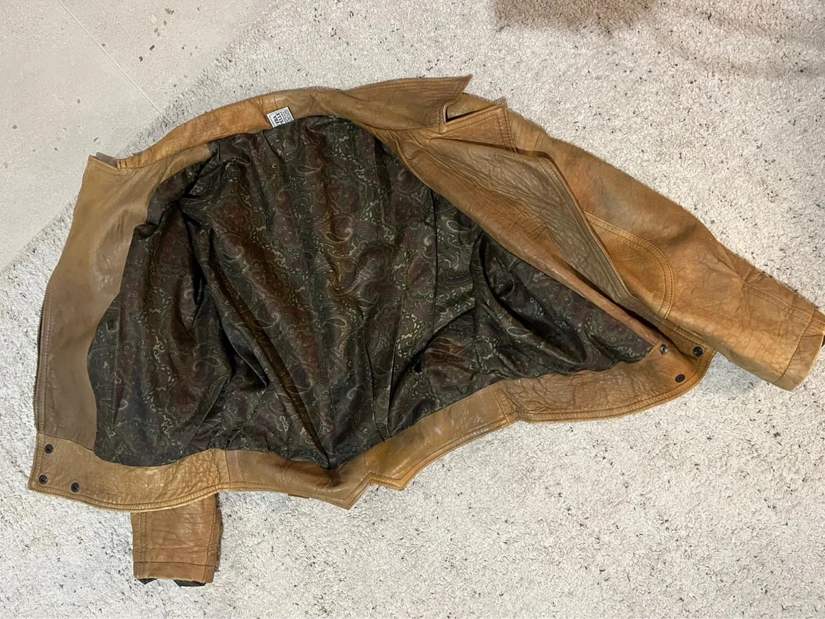 Cuir véritable. Vintage. Modèle bomber.Présente les usures typiques des vêtements vintage mais aucun défaut particulier. 6