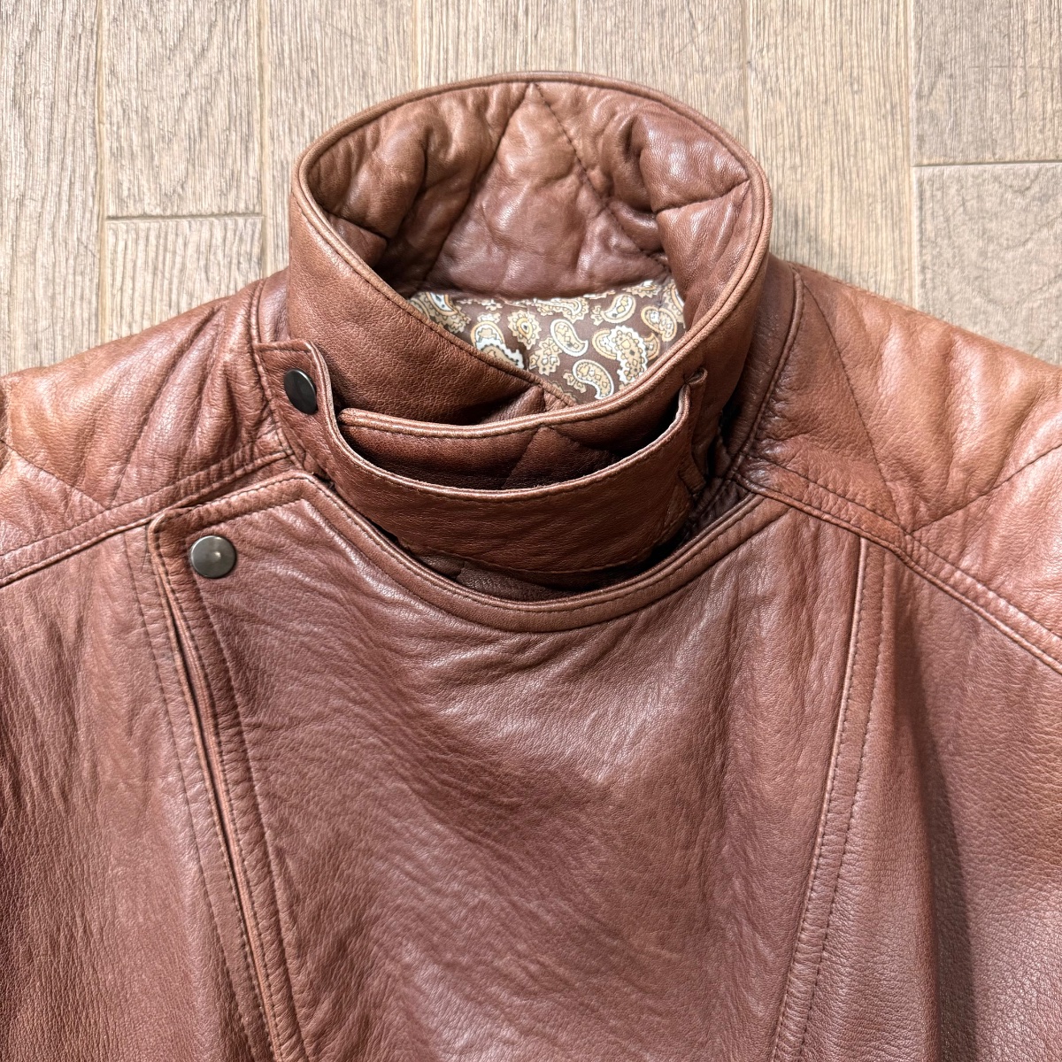 Brown leather aviator jacket with stand-up collar, asymmetrical snap button closure and quilted details. Inspired by Girbaud Sicons Giorgio Armani 4