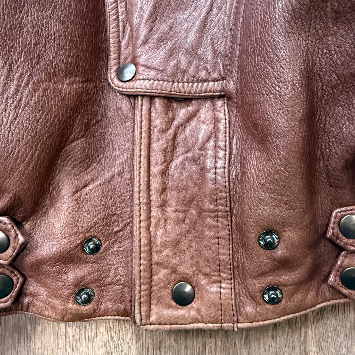 Brown leather aviator jacket with stand-up collar, asymmetrical snap button closure and quilted details. Inspired by Girbaud Sicons Giorgio Armani 5