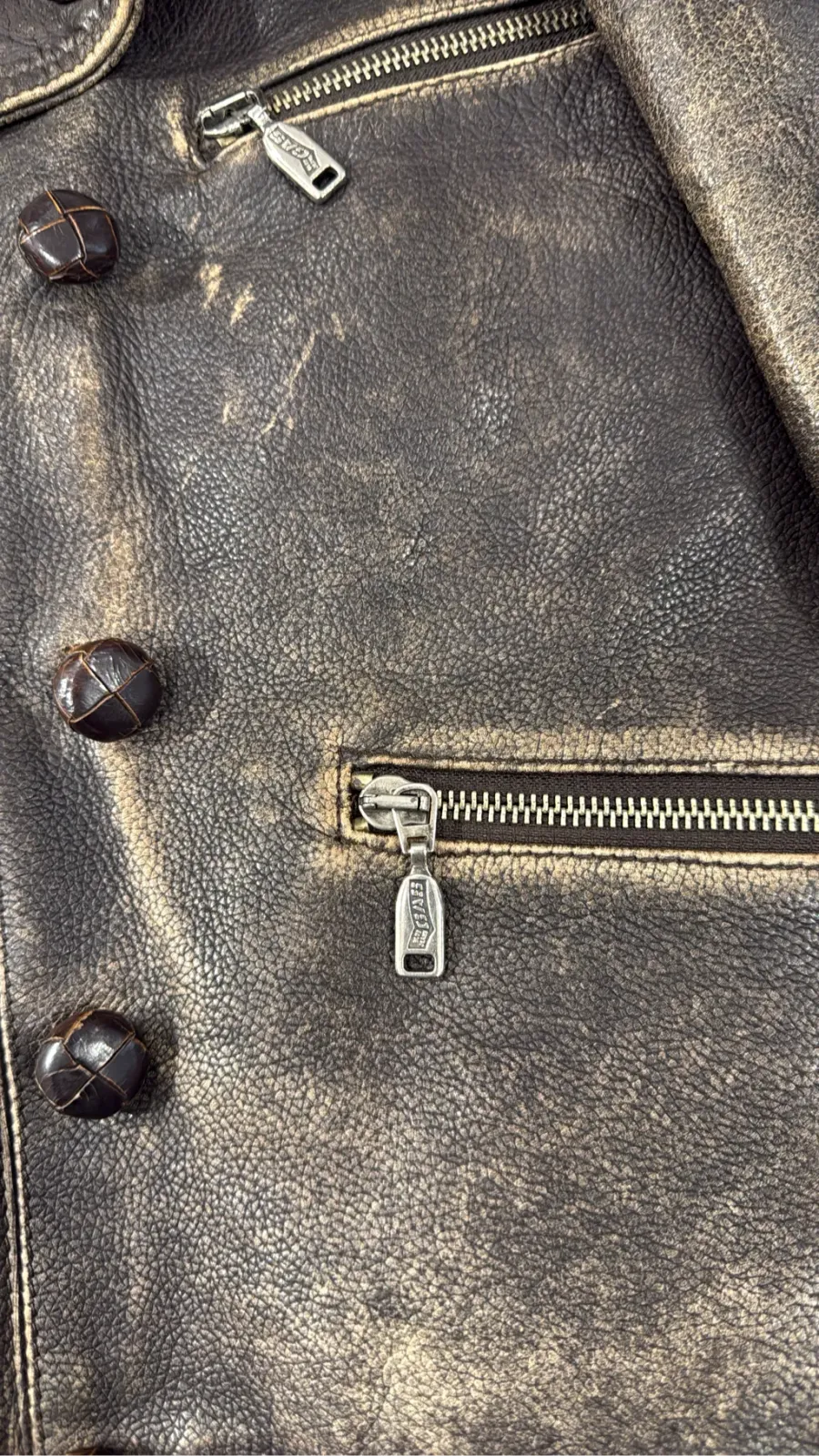 Double-breasted brown cowhide leather motorcycle jacket by GAS, with a distressed finish and zip details. 5