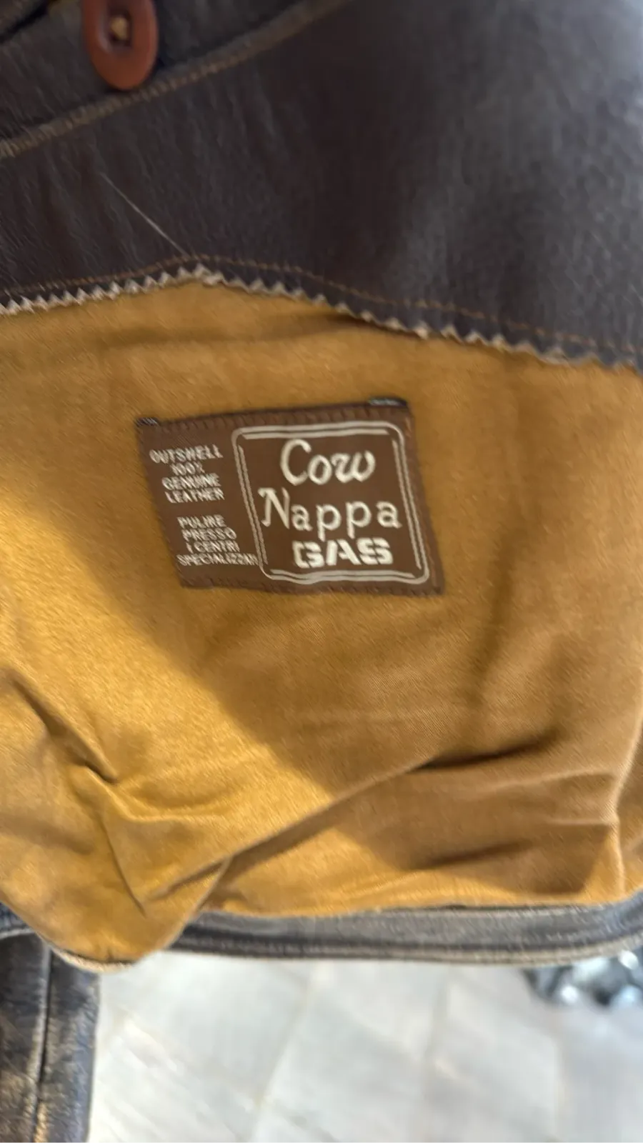 Double-breasted brown cowhide leather motorcycle jacket by GAS, with a distressed finish and zip details. 3