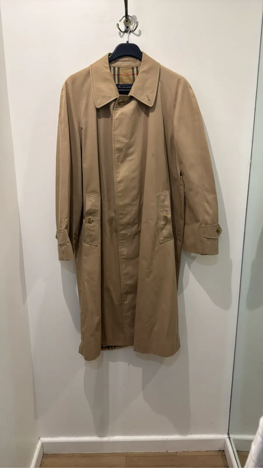 Classic Burberrys' trench coat in camel with check lining, showing a few visible stains on the front.