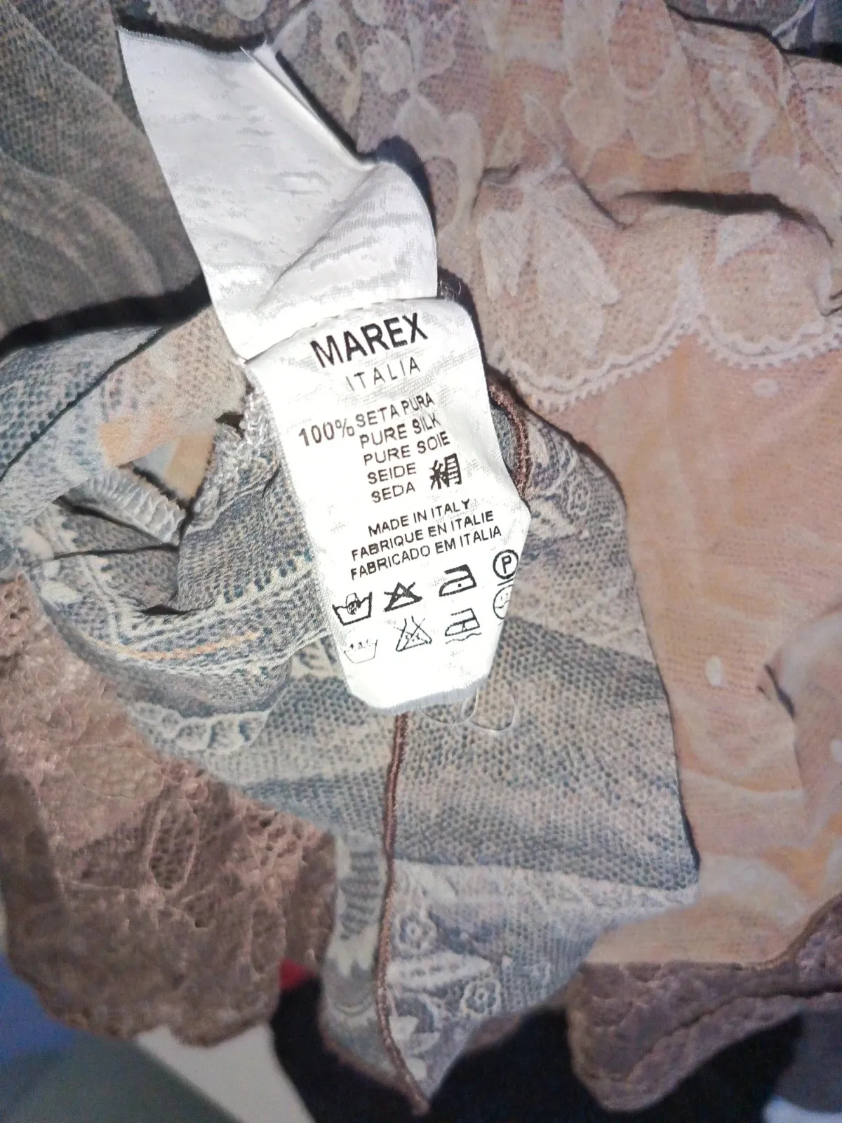 Asymmetric with lace at the hem. 100% silk outer, 100% cotton lining. Made in Italy. 4