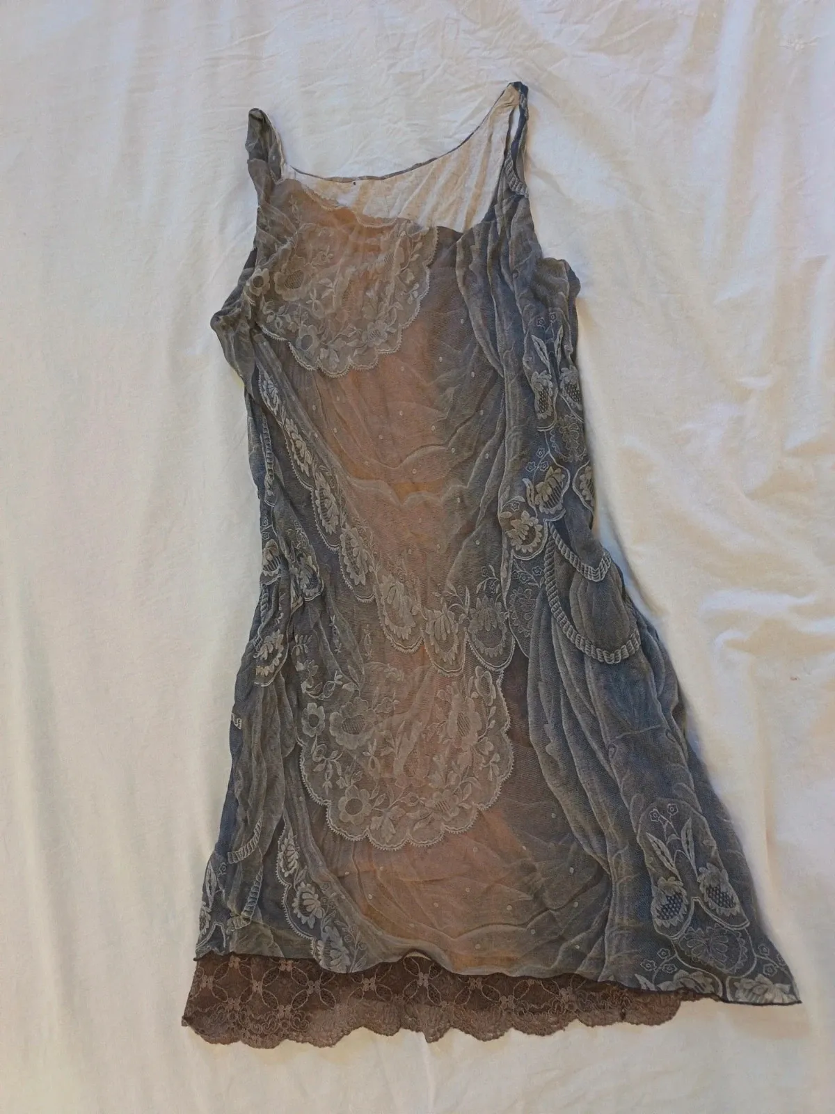 Asymmetric with lace at the hem. 100% silk outer, 100% cotton lining. Made in Italy.