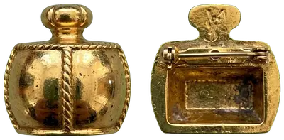 Small brooch shaped like a gilded ornate miniature bottle. YSL